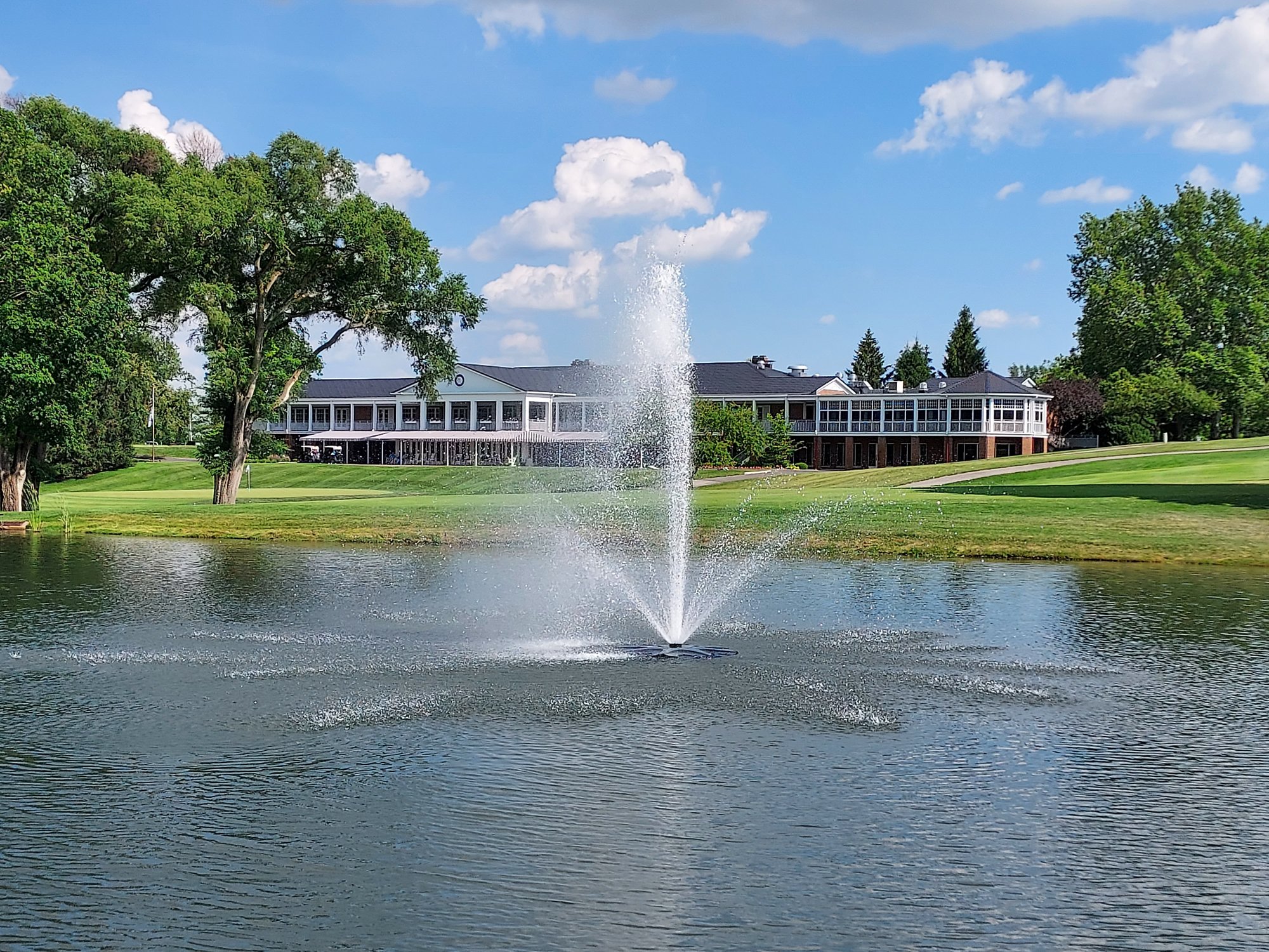 pond with fountain in front of clubhouse